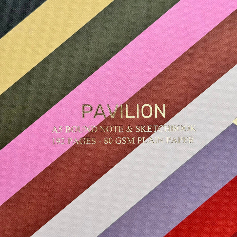 Close-up of Radar A5 notebook showing colourful diagonal stripes, gold foil detail and buckram embossed cover.