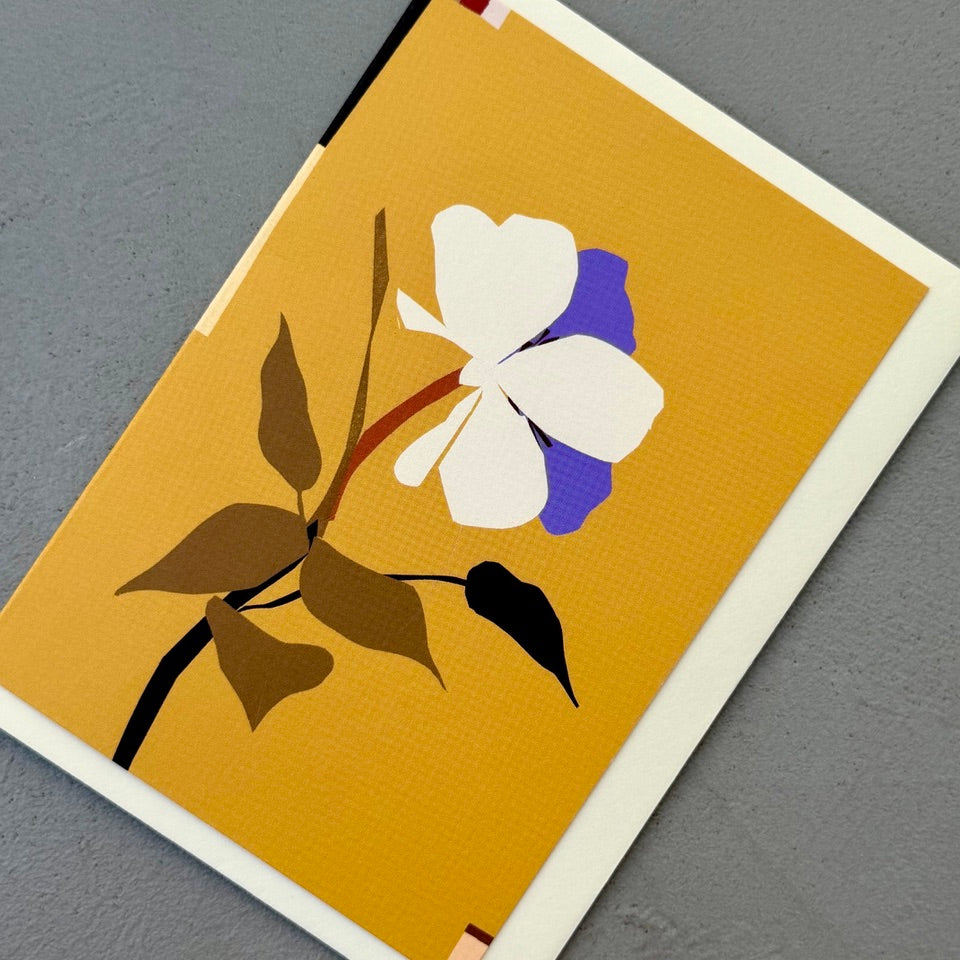 Angled view of the Anemone greeting card on a cream envelope.