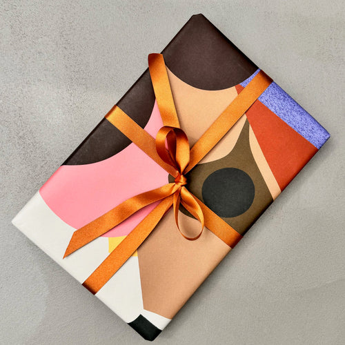 Gift wrapped in Assemblage paper with orange satin ribbon