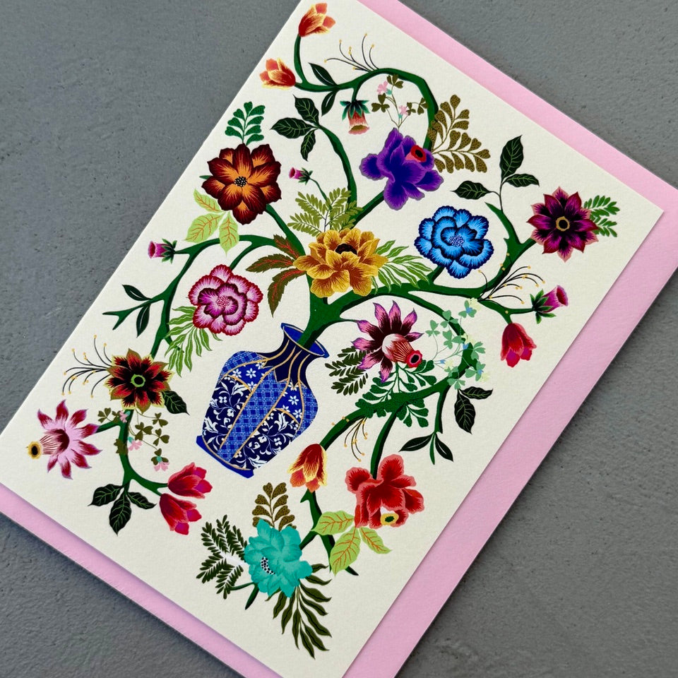 Angled view of the Blue Vase greeting card with a soft pink envelope, showcasing the detailed floral illustration and decorative vase.
