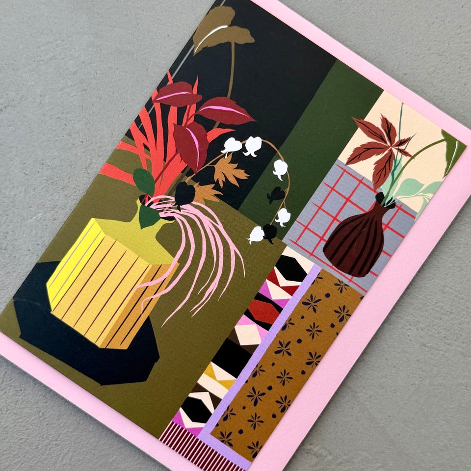 Angled view of the Botanical Interior greeting card on a pink envelope.