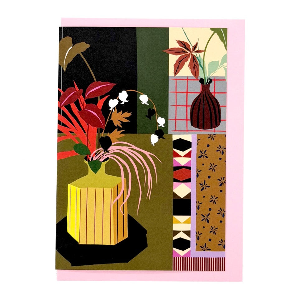 Greeting card featuring an illustrated botanical interior with decorative vases and foliage on a pink envelope.