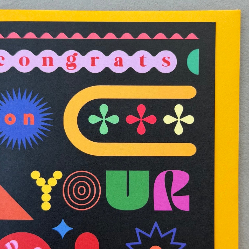 Close-up of the colourful typography and geometric shapes on the Congrats On Your Special Day greeting card.