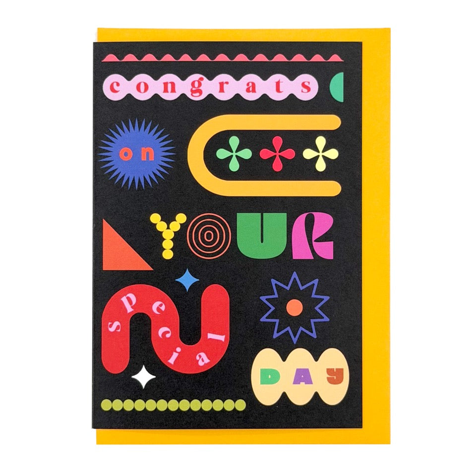 Bold typographic greeting card reading "Congrats On Your Special Day" in colourful geometric lettering on a black background with a mustard yellow envelope.