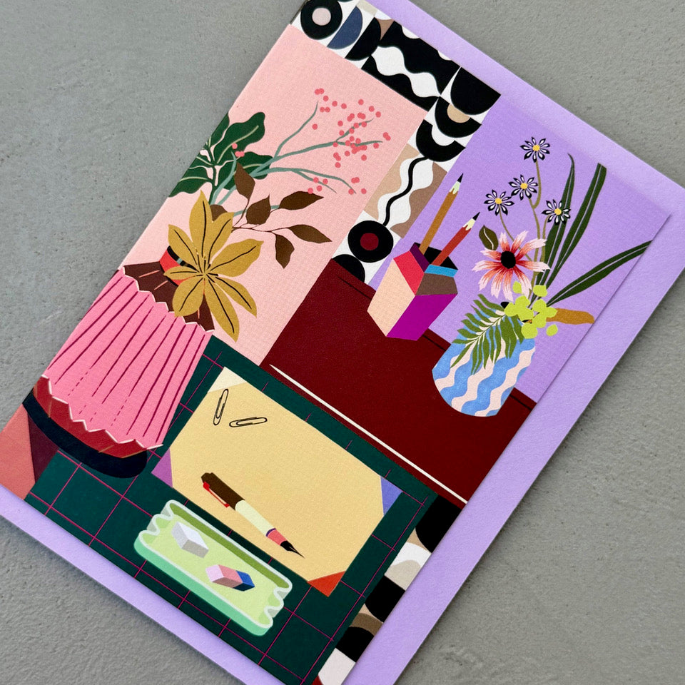 Angled view of the Creative Corner greeting card on a lilac envelope.