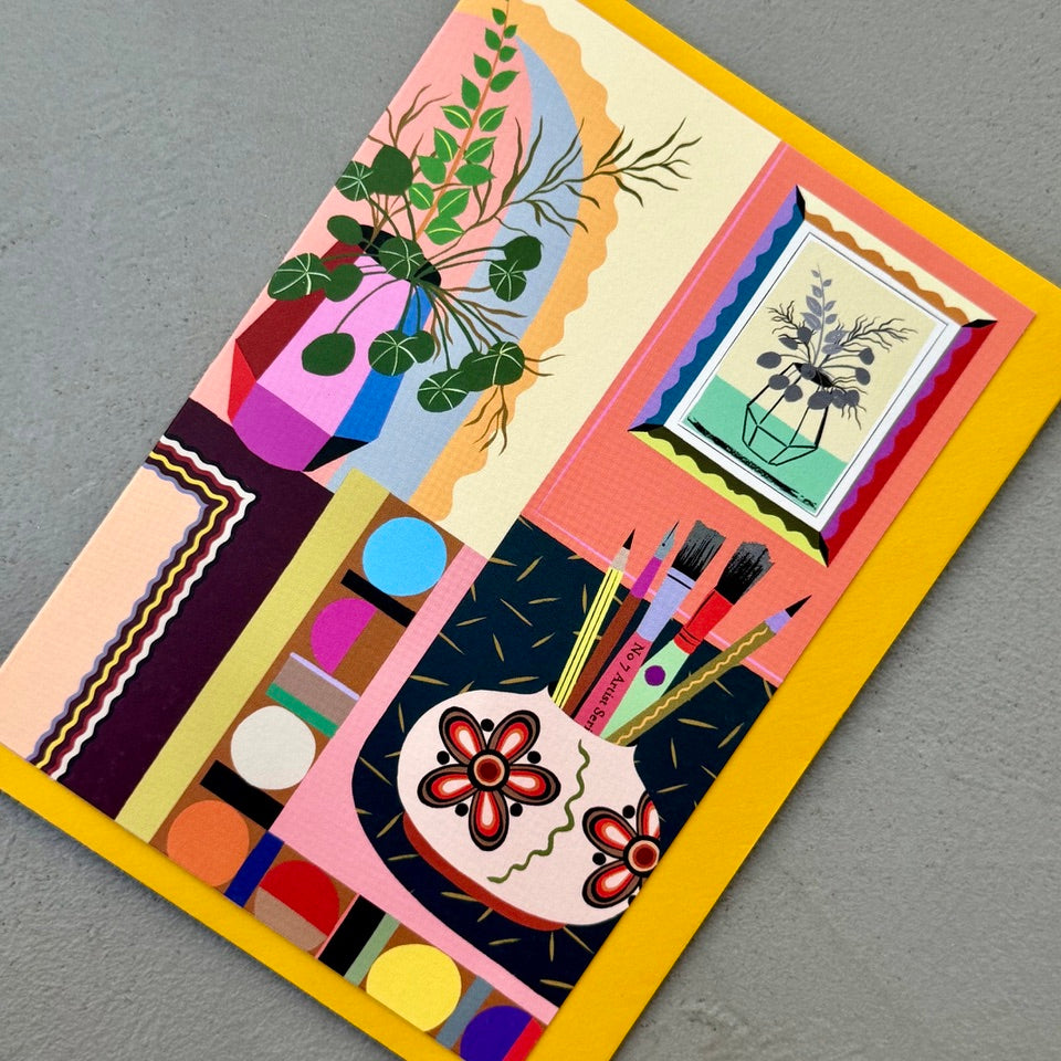 Angled view of the Creative Interior greeting card on a mustard envelope.