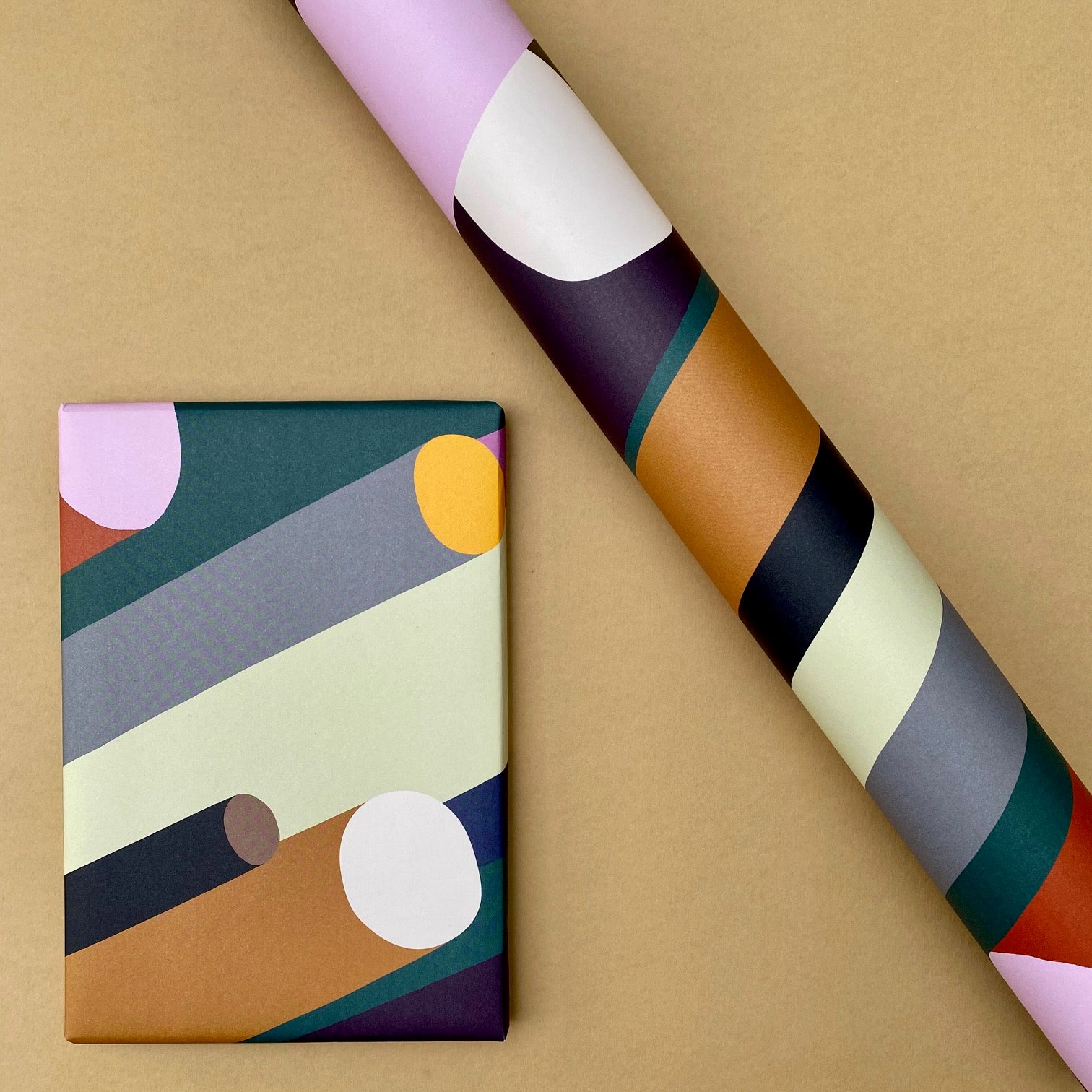 Cylinder wrapping paper shown as a wrapped gift alongside a roll of the design