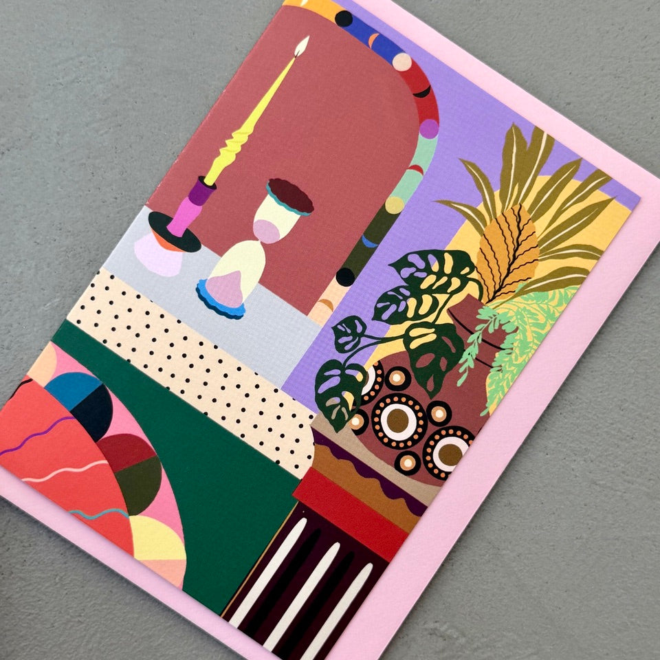 Angled view of the Decorative Interior greeting card on a pink envelope