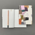 Etch Notebook shown with open multi-layout pages and pencil