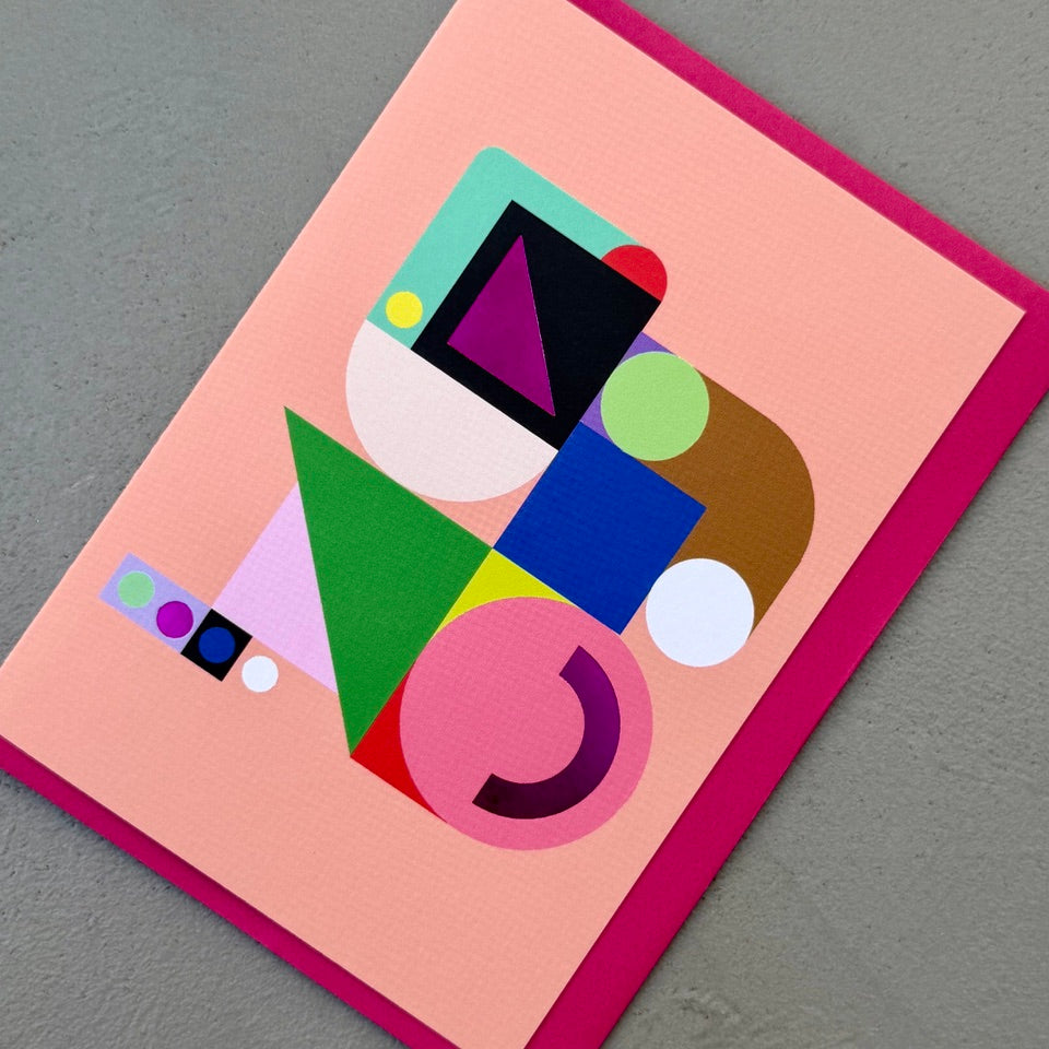 Angled view of the Geometric Abstract No.1 greeting card with a bright pink envelope, showcasing the abstract geometric artwork and purple foil finish.
