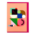 Modern abstract geometric greeting card featuring bold colourful shapes with purple foil details on a soft peach background, paired with a bright pink envelope.