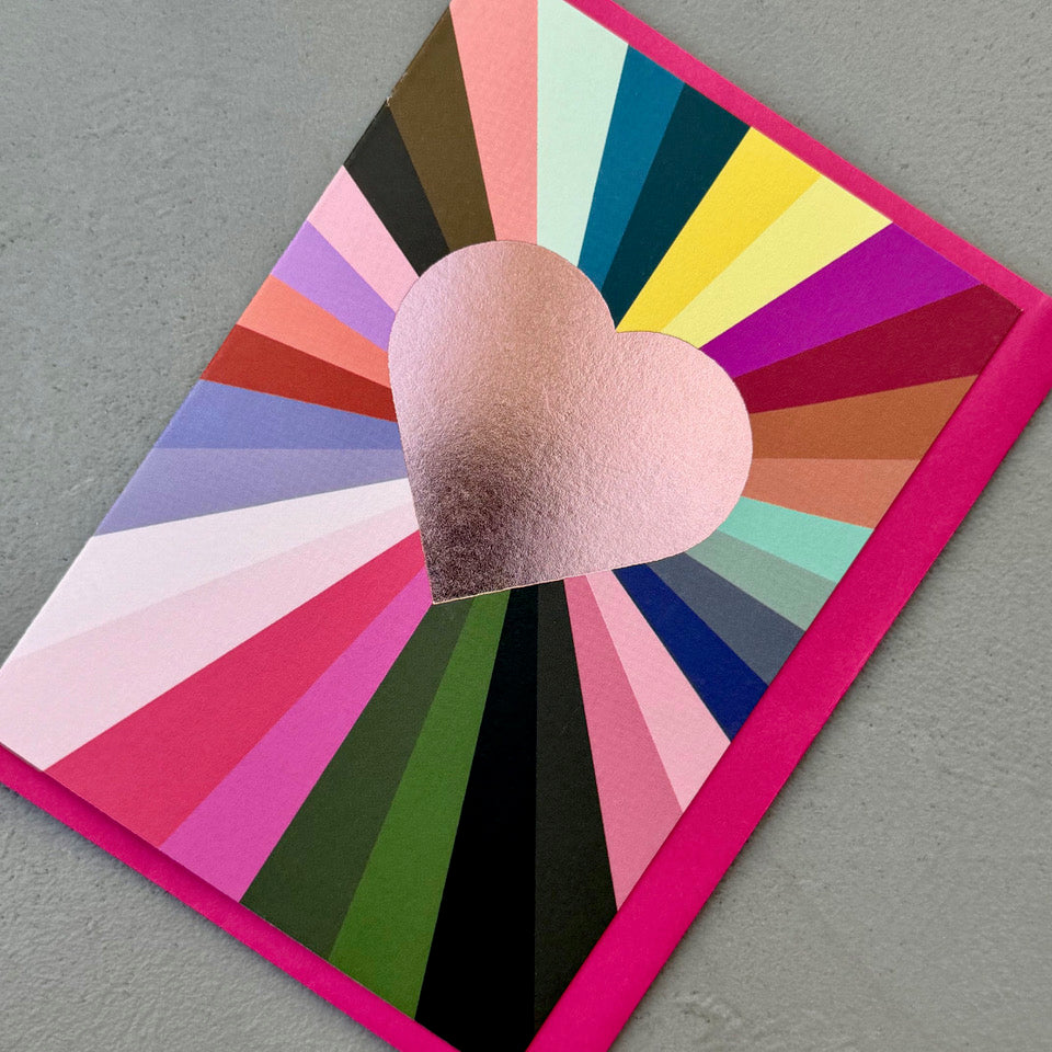 Angled view of the Gold Foil Heart Card on a bright pink envelope.