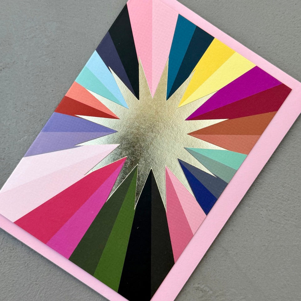 Angled view of the Gold Foil Sunburst Card on a pale pink envelope.
