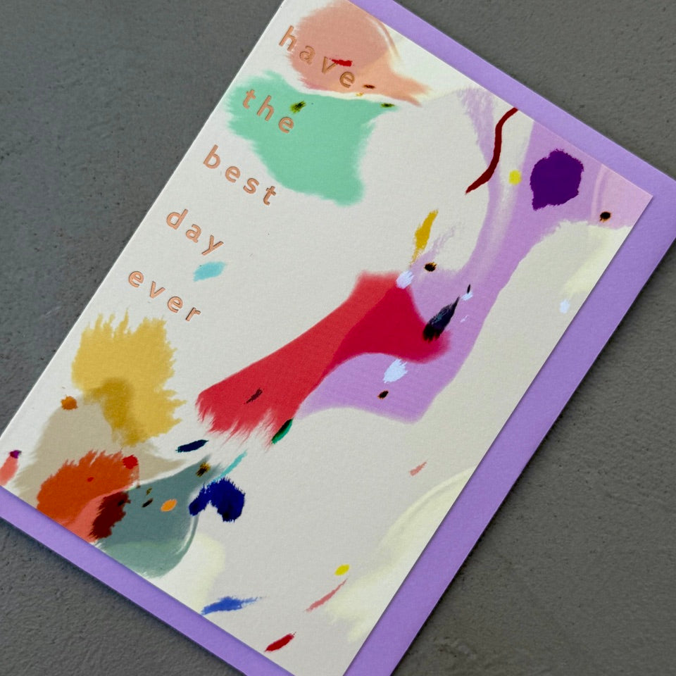 Angled view of the Graphic Expression 05 greeting card with its lavender envelope.
