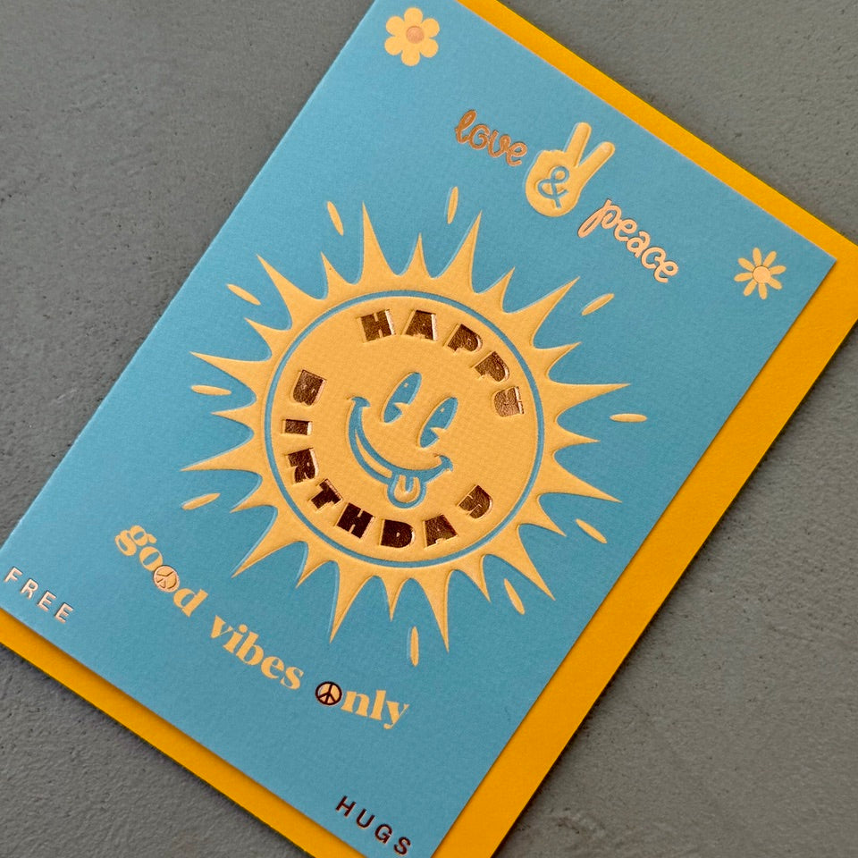 Angled view of the Happy Birthday Good Vibes Only greeting card with a bright yellow envelope, highlighting the playful retro design and foil finish.