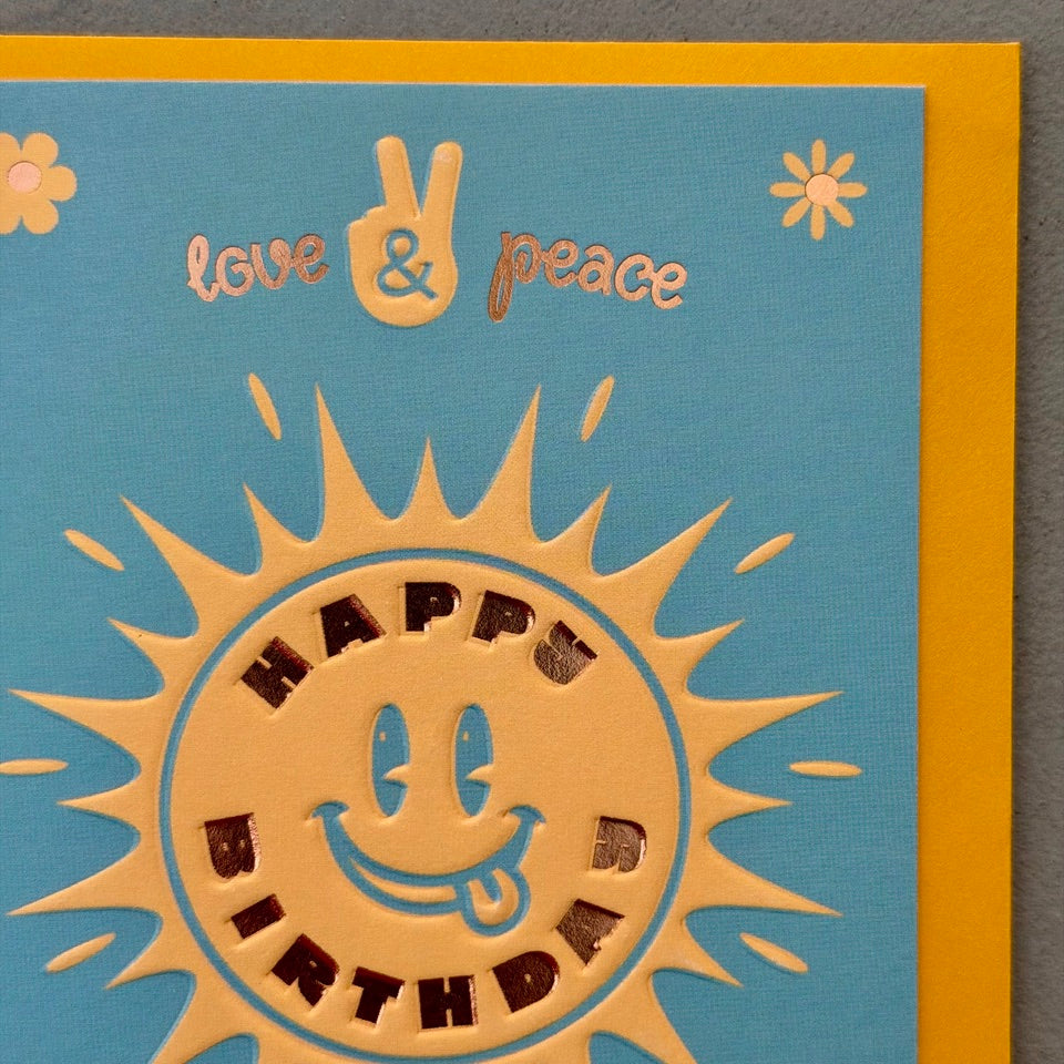 Close-up of the Happy Birthday Good Vibes Only design showing the smiling sun illustration and shimmering metallic foil details.