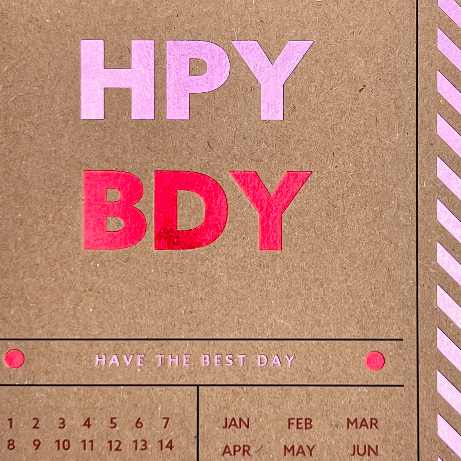 Close-up of the pink and red foiled Happy Birthday lettering
