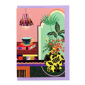 Greeting card featuring an illustrated home interior with houseplants, a patterned vase and a cup of coffee on a lilac envelope.