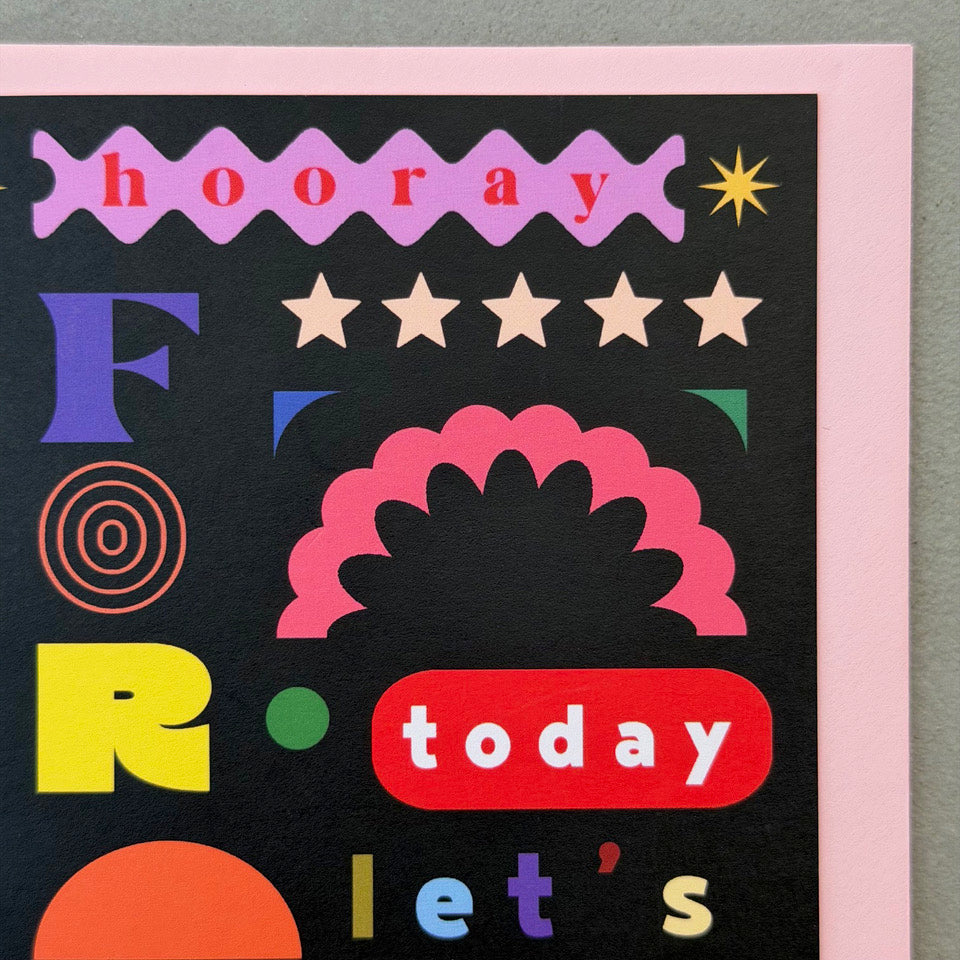 Close-up of the colourful typography and geometric shapes on the Hooray For Today Let's Party greeting card.
