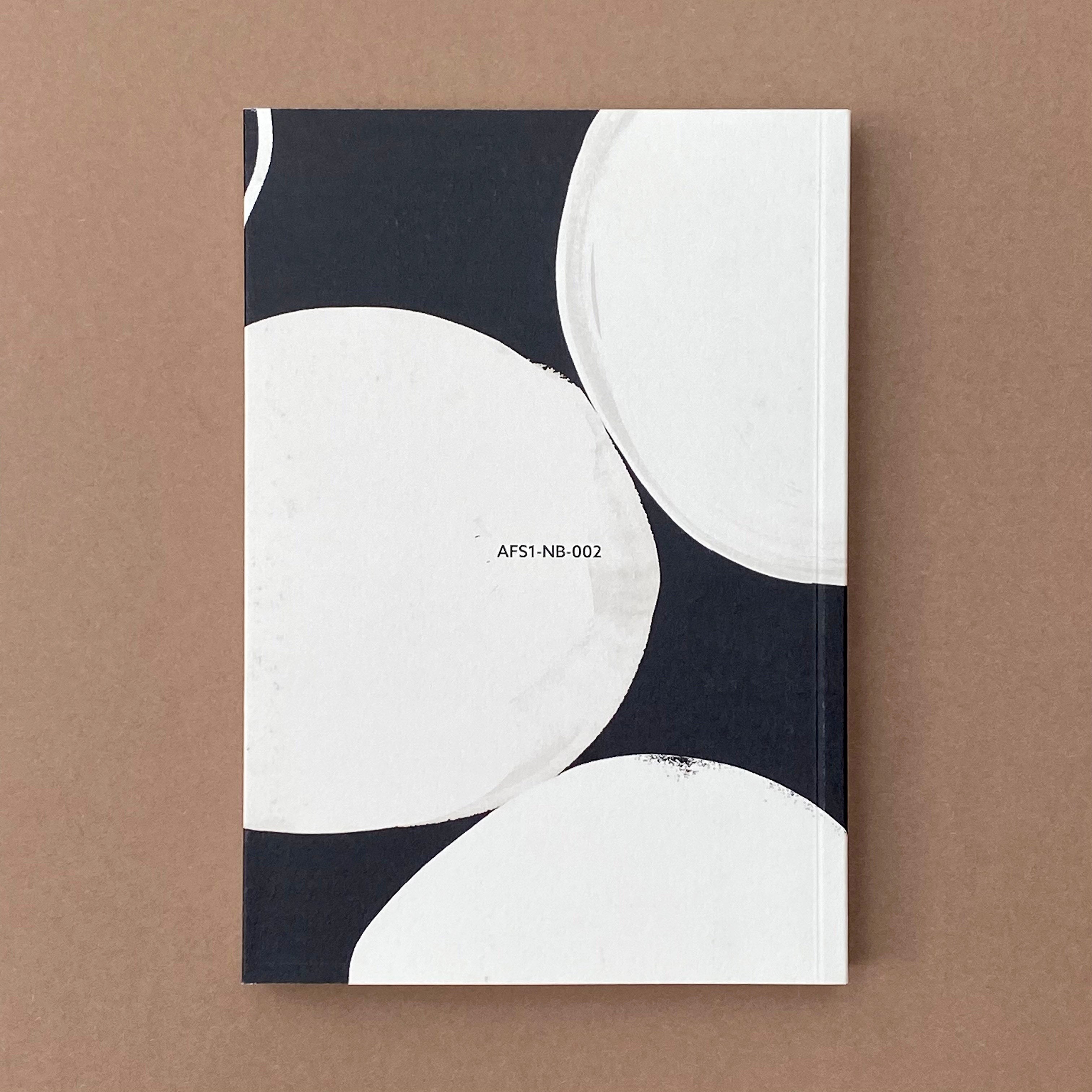 Back cover of Ink Notebook with monochrome abstract circular design