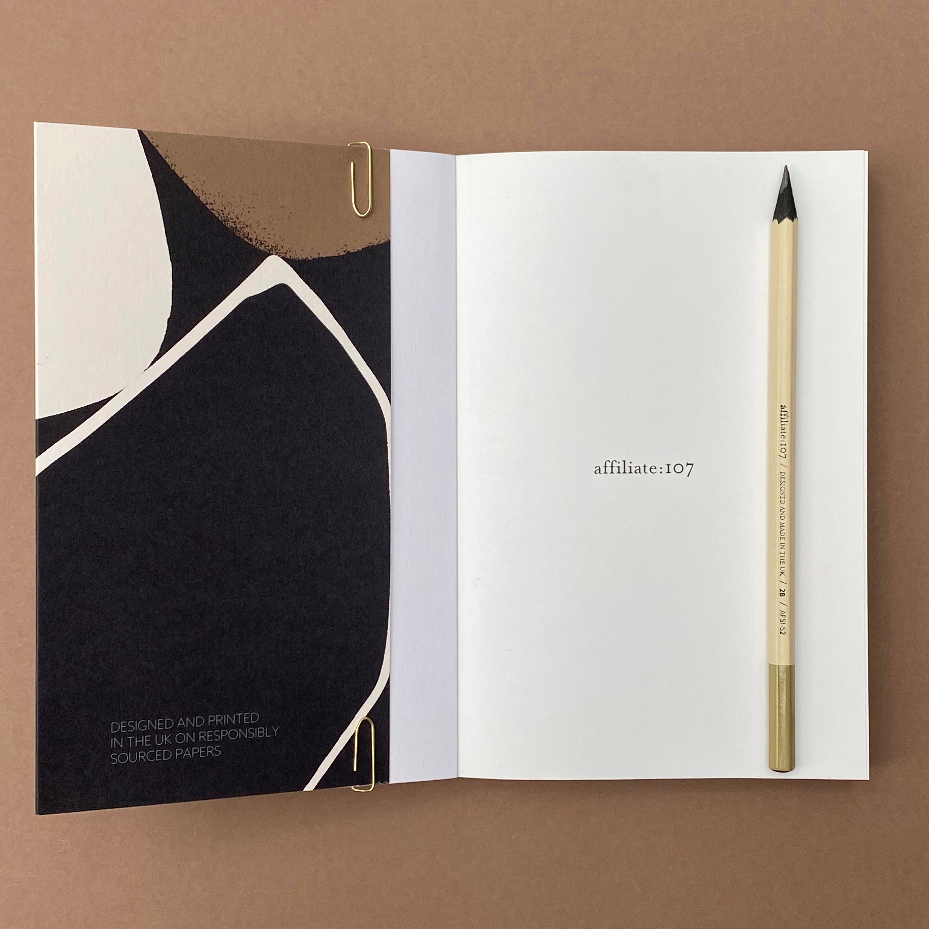 Ink Notebook open showing extended gate-fold cover and blank page