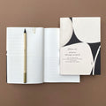 Ink Notebook shown with open multi-layout pages and pencil