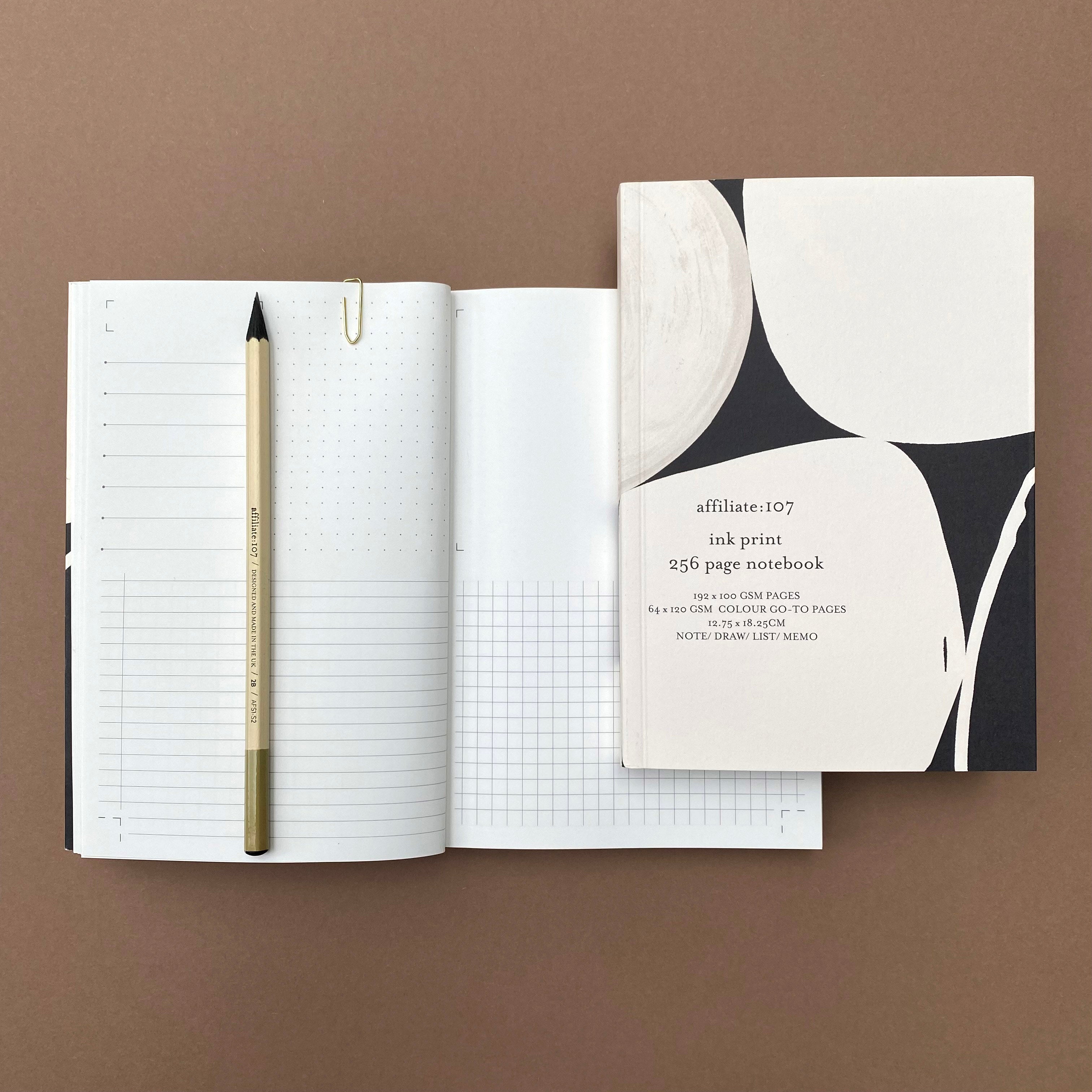 Ink Notebook shown with open multi-layout pages and pencil