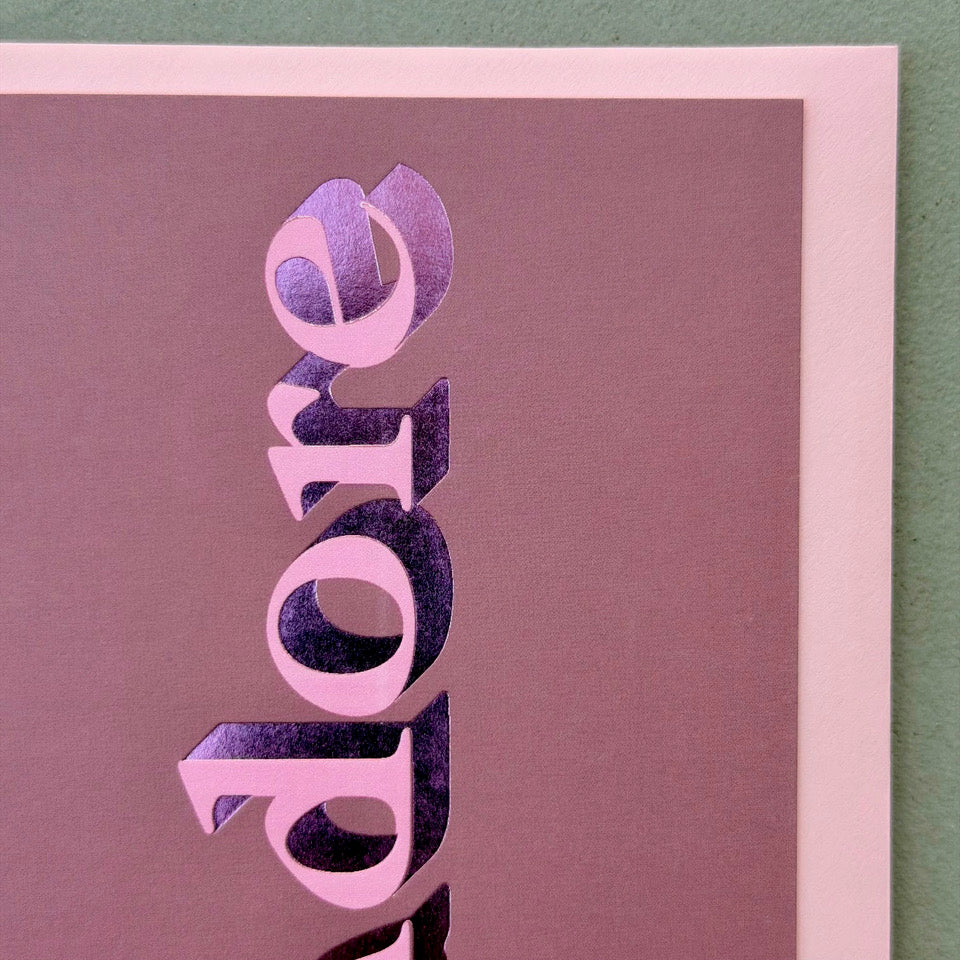 Close-up of the pink lettering and metallic pink foil detail on the mauve J’adore card.
