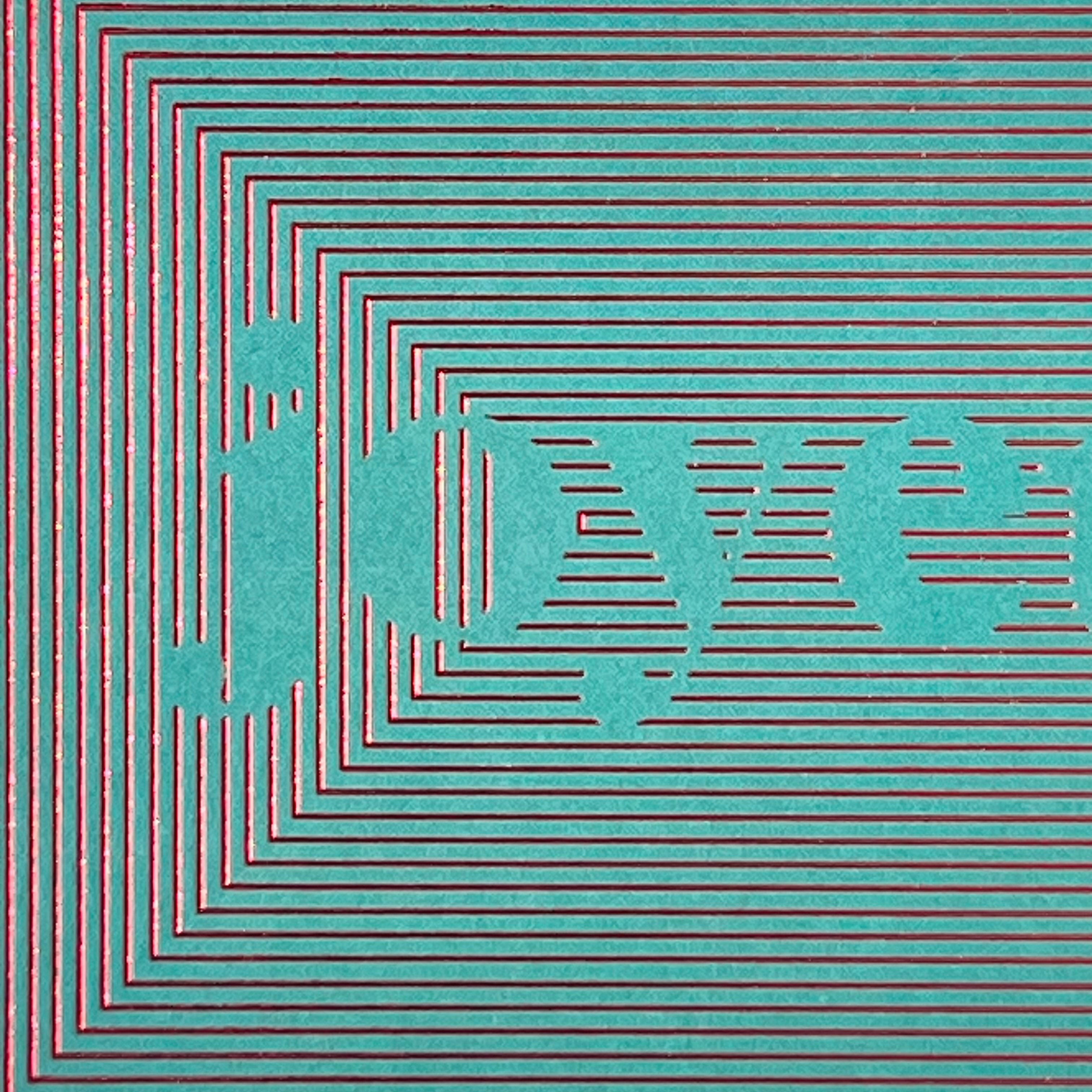 Close-up of the red foiled Joyeux Noël linear design