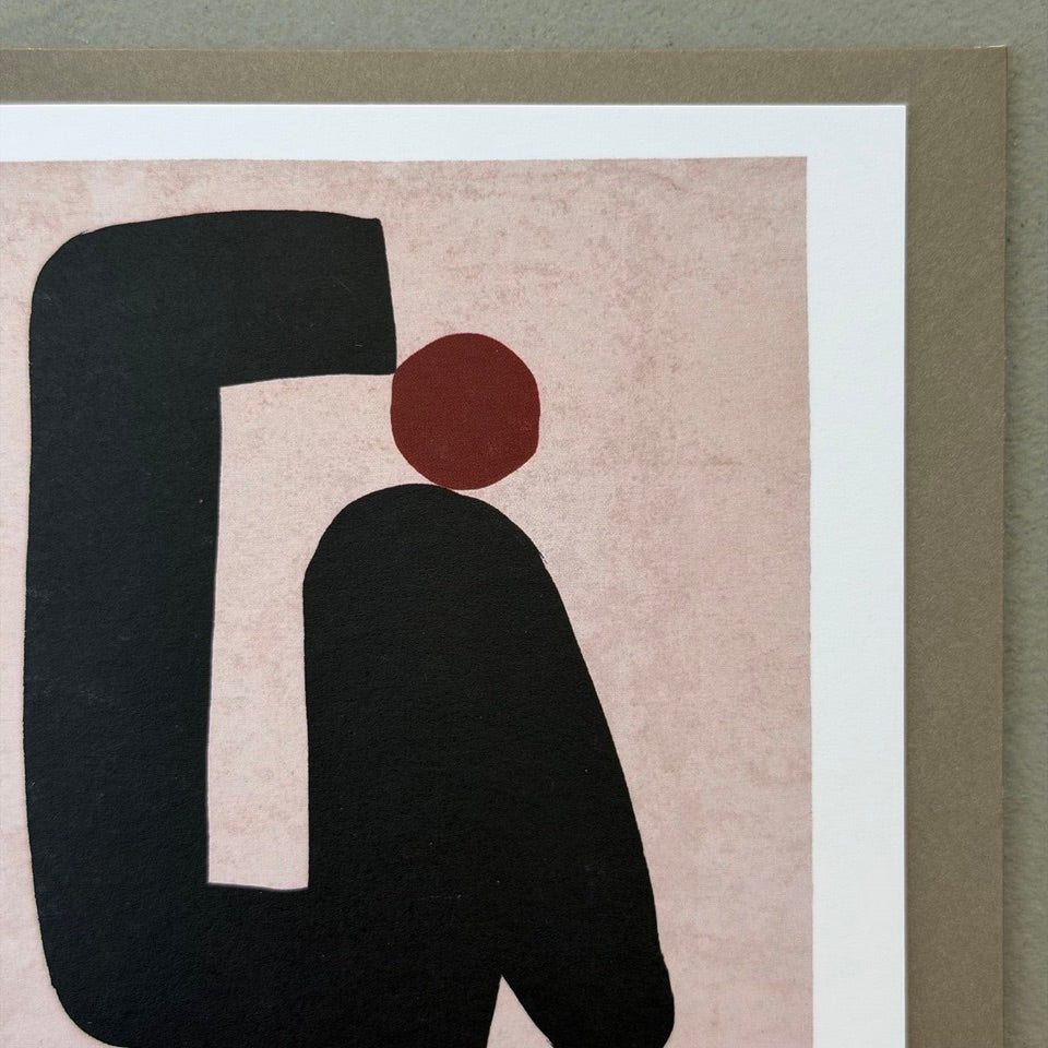 Close-up of the abstract black shapes and rust-red circle on the Keep Moving Forward greeting card.