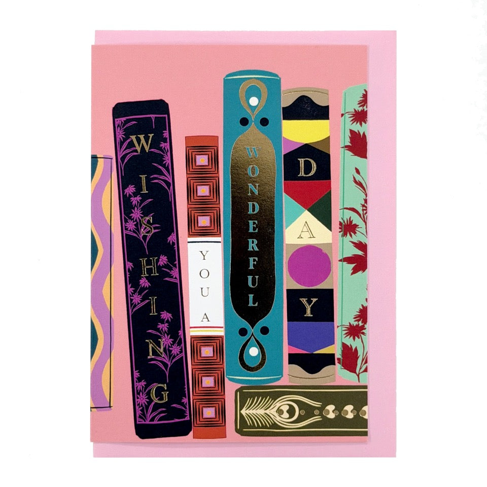 Wishing You a Wonderful Day card featuring an illustrated bookshelf with colourful decorative book spines, shown with a pale pink envelope.
