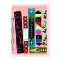 Library Collection 01 greeting card featuring an illustrated bookshelf with colourful decorative book spines spelling "Wishing You a Wonderful Day", shown with a pale pink envelope.
