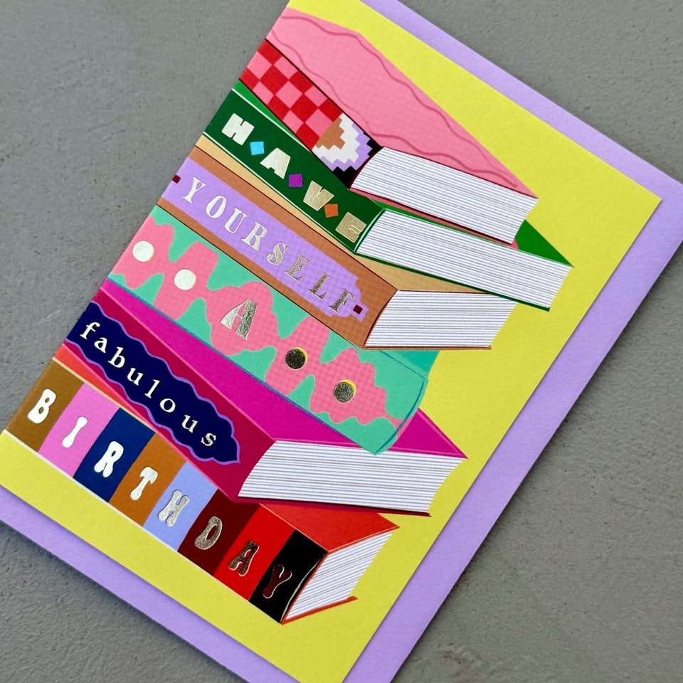 Angled view of the Library Collection 12 birthday card with its lavender envelope.

