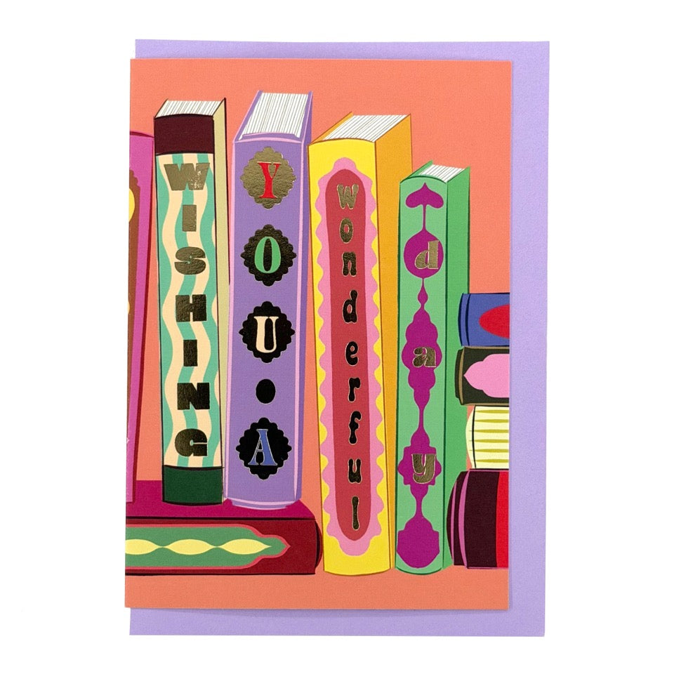 Wishing You a Wonderful Day card featuring illustrated books with colourful decorative spines, shown with a lavender envelope.
