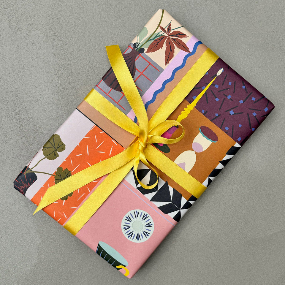 Wrapped gift in Lifestyle wrapping paper with yellow ribbon