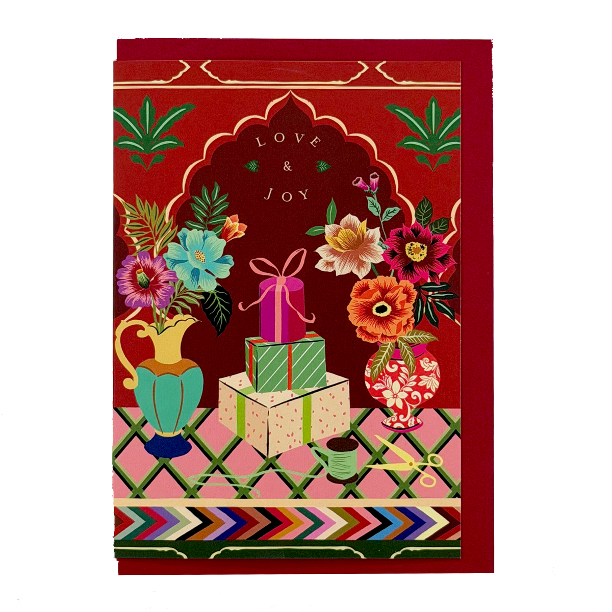 Love & Joy Christmas card by PAVILION featuring flowers, wrapped presents and a red envelope
