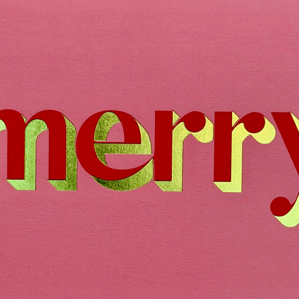 Close-up of the red and green foiled Merry lettering
