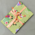 Wrapped gift in Mixology wrapping paper with peach ribbon