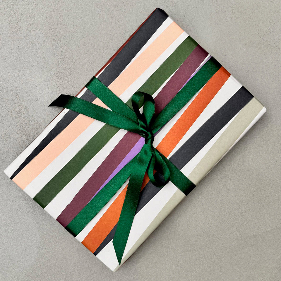 Wrapped gift in Mondo wrapping paper with dark green ribbon