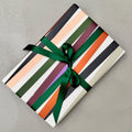 Wrapped gift in Mondo wrapping paper with dark green ribbon