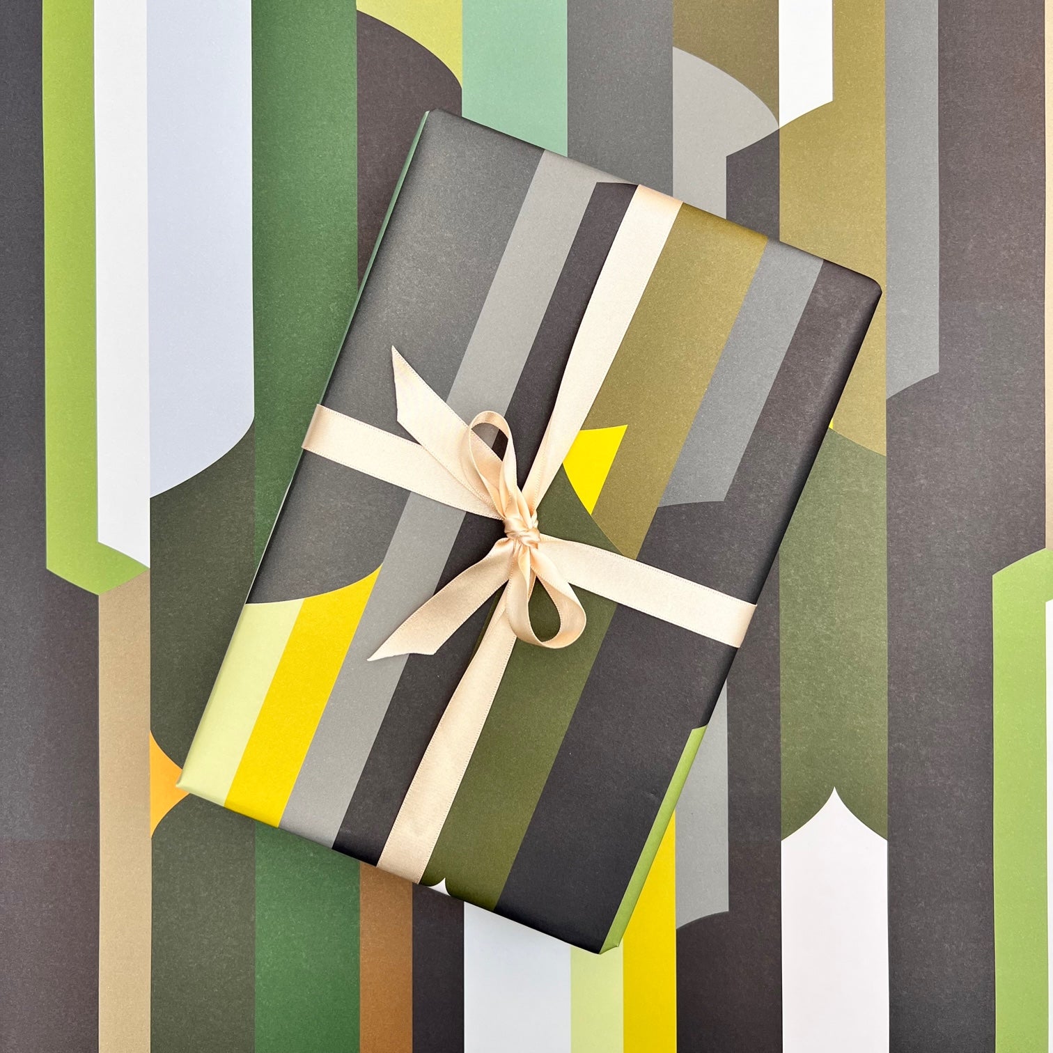 Monolith geometric wrapping paper with wrapped gift and neutral ribbon