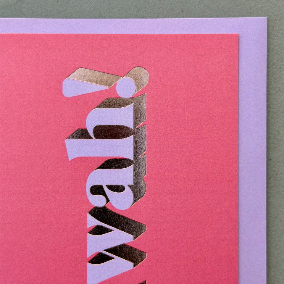 Close-up of the lilac lettering and gold foil detail on the bright pink Mwah! card.