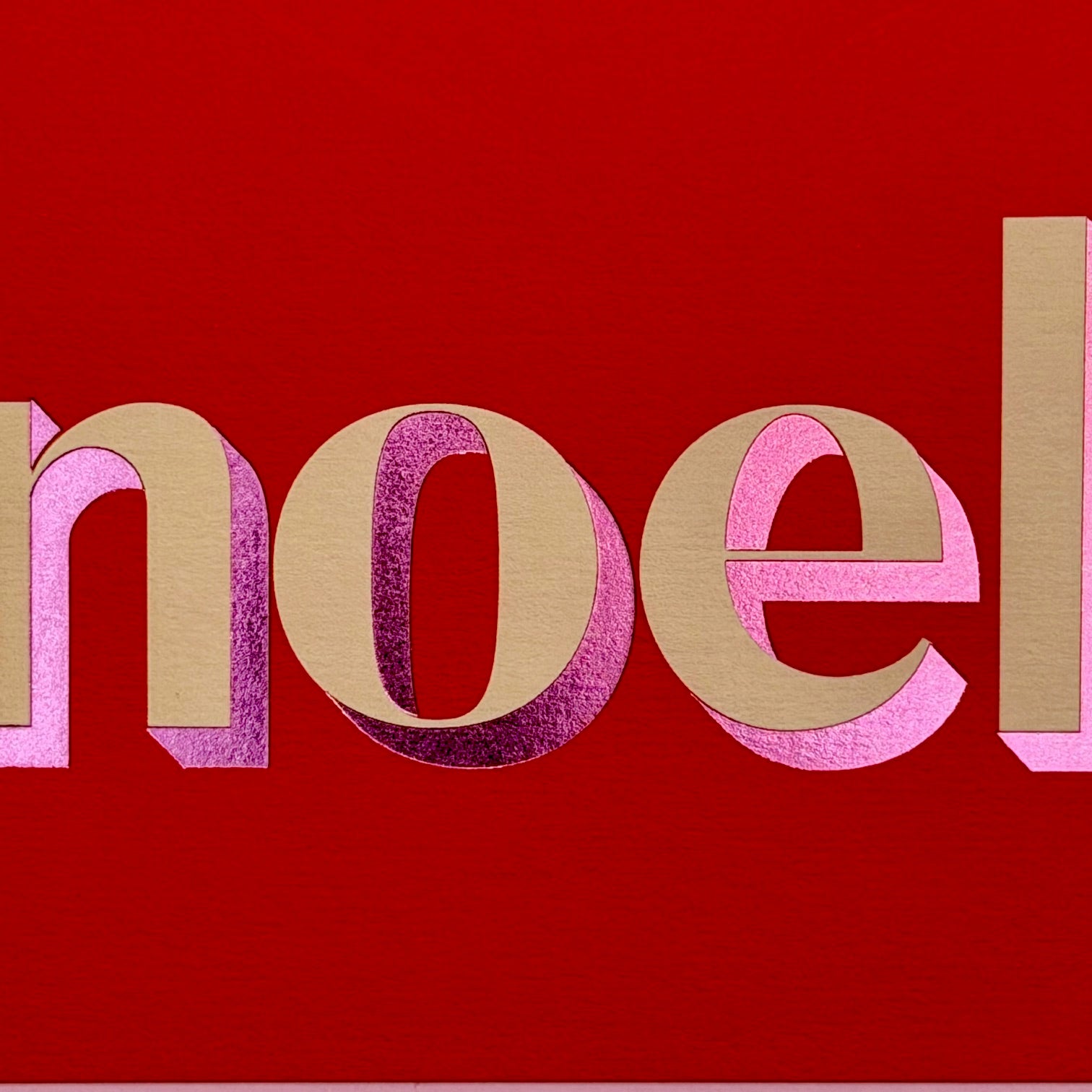 Close-up of the cream and pink foiled Noel lettering