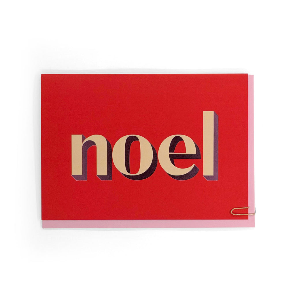 Noel Christmas card with cream and pink foiled typography on a red background