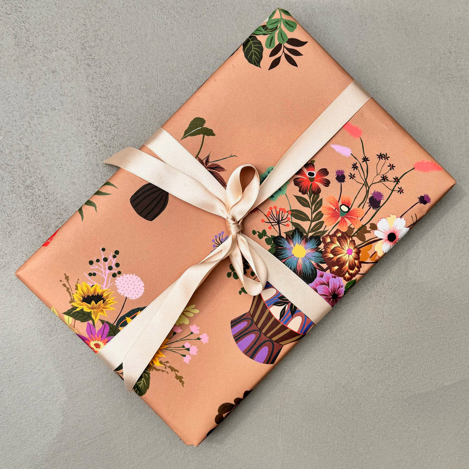 Wrapped gift in Objet floral wrapping paper with neutral ribbon