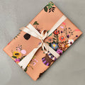 Wrapped gift in Objet floral wrapping paper with neutral ribbon