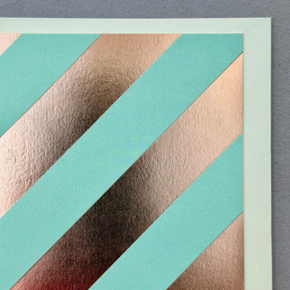 Close-up of the Oblique greeting card highlighting the wide diagonal copper foil stripes and contemporary minimalist design.
