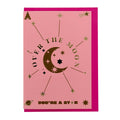 Foil-embellished greeting card featuring a crescent moon, stars and the message "Over the Moon You're a Star", paired with a bright pink envelope.