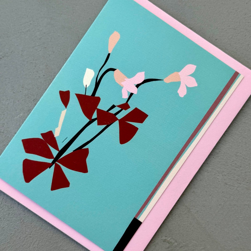 Angled view of the Oxalis greeting card on a pink envelope.