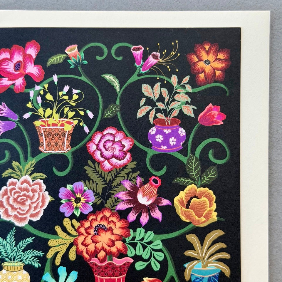 Close-up of the Painted Garden design highlighting vibrant flowers, ornamental pots and intricate botanical details against a black background.